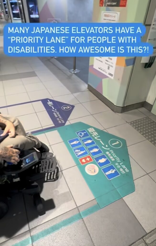 En person i kørestol benytter et særligt forbeholdt spor for personer med handicap i nærheden af en elevator i Japan. Skilte og markeringer på gulvet angiver tilgængelighed og fortrinsret.